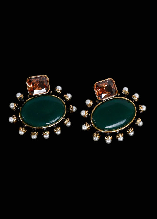 A pair of gold-tone statement earrings featuring a large oval dark green stone, a smaller square amber-brown stone above it, and a border of small white pearls,