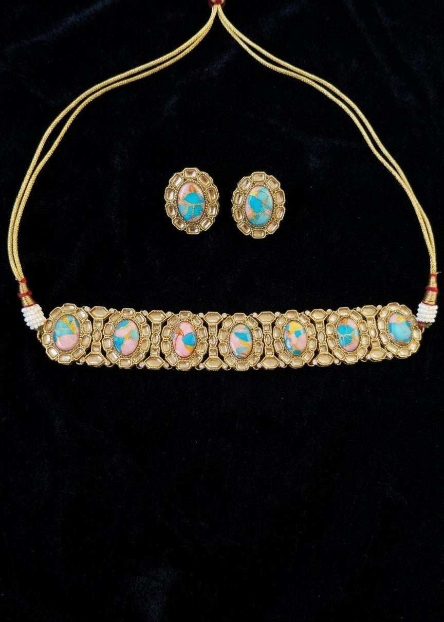 Gold-plated traditional Indian jewelry set featuring a choker necklace with seven oval opal inlays and matching stud earrings, displayed on a black velvet background.