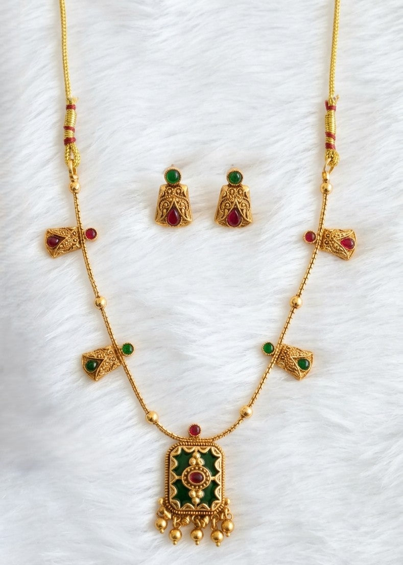 Antique type gold plated necklace set with green and red stone embellishments with green enamel pendant. 