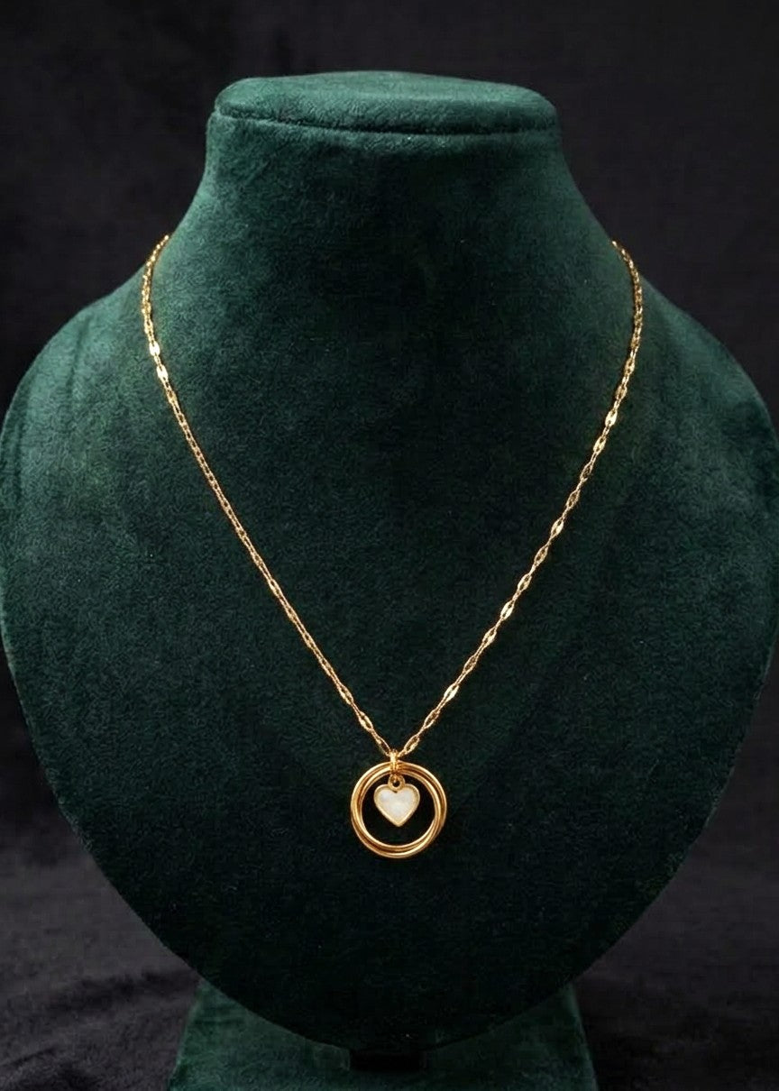 Afreen gold-toned heart and ring necklace on a green mannequin background, showing the textured chain and extension clasp.