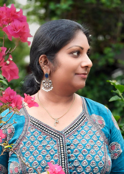 A woman wearing a silver earrings 