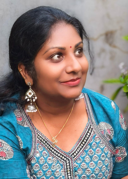 A woman wearing a silver earrings 