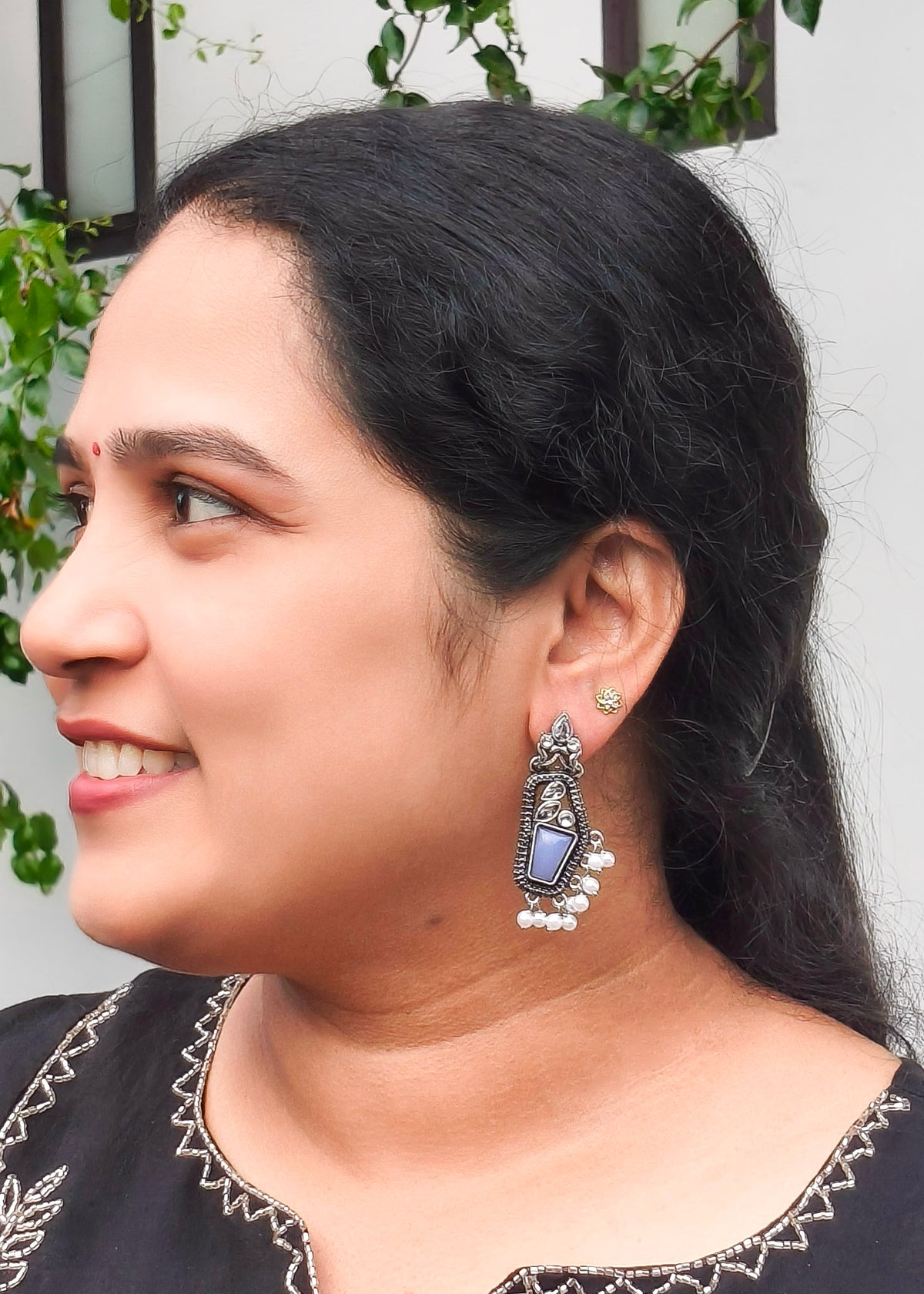 A woman wearing Oxidized silver earring