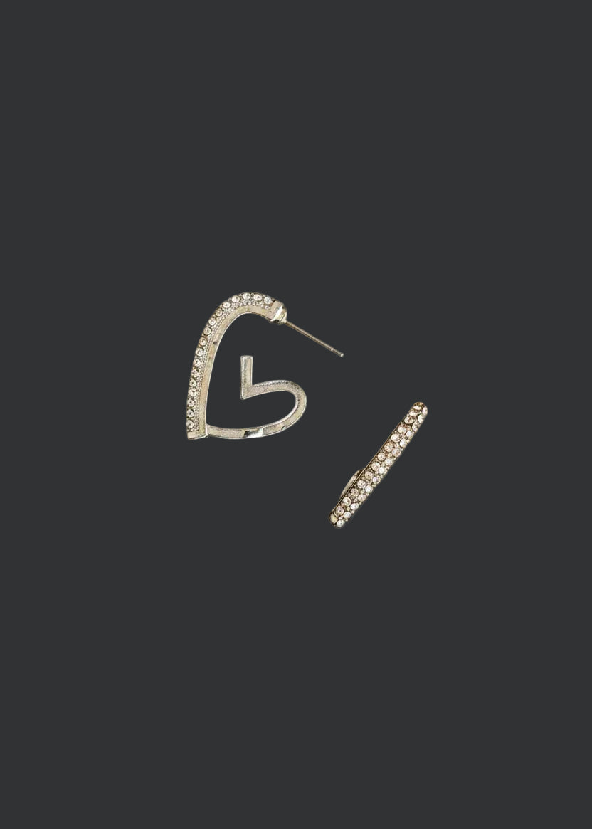 A pair of silver-toned hoop earrings with small clear stones along the top curve