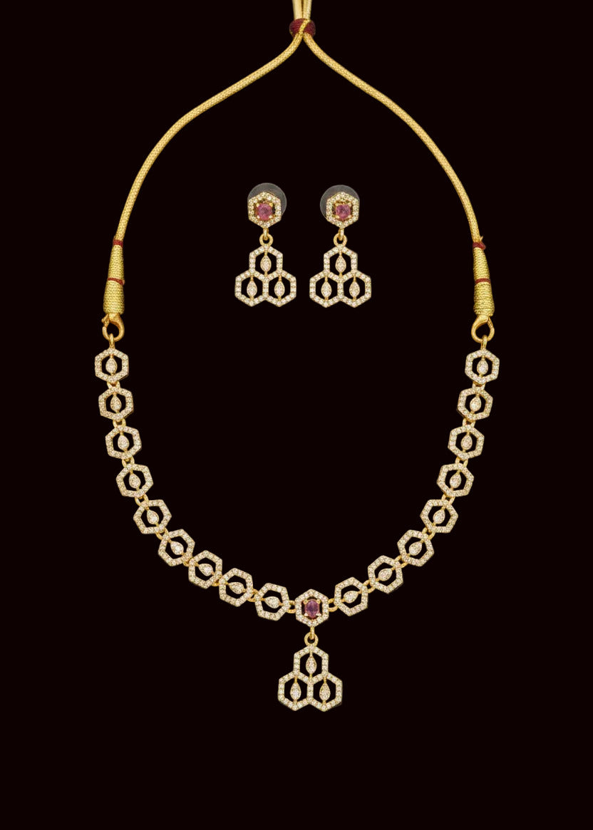 Gold-toned traditional Indian jewelry set featuring an American diamond necklace, matching earrings