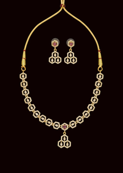Gold-toned traditional Indian jewelry set featuring an American diamond necklace, matching earrings