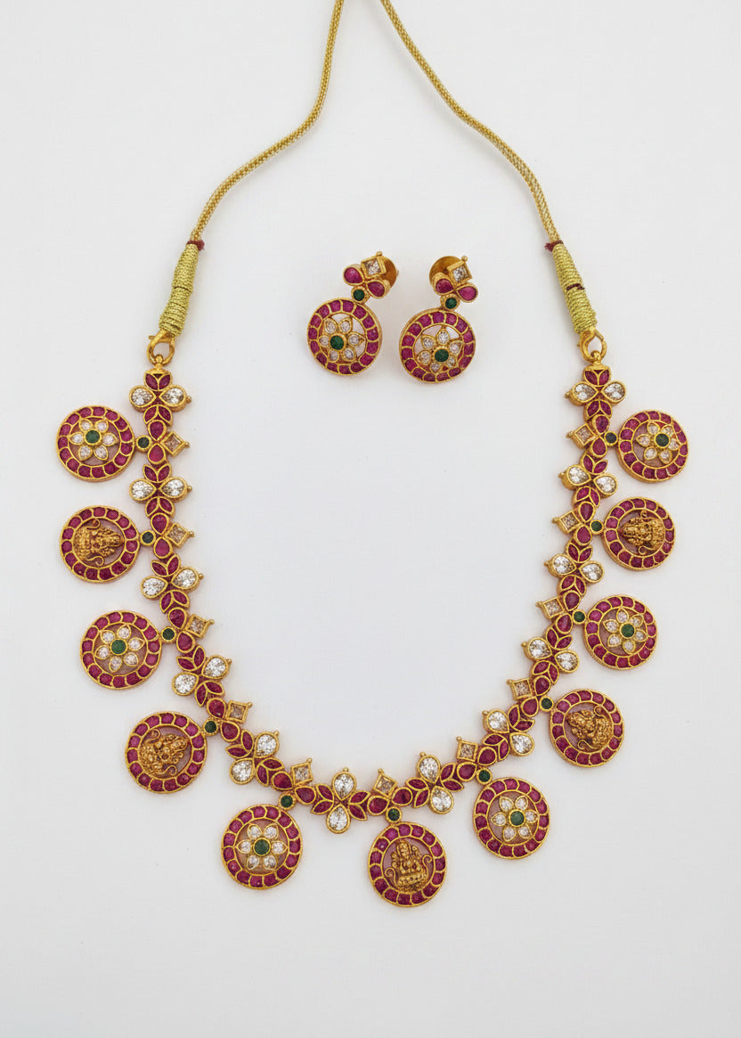 Gold-plated necklace and matching earrings with red and green enamel details