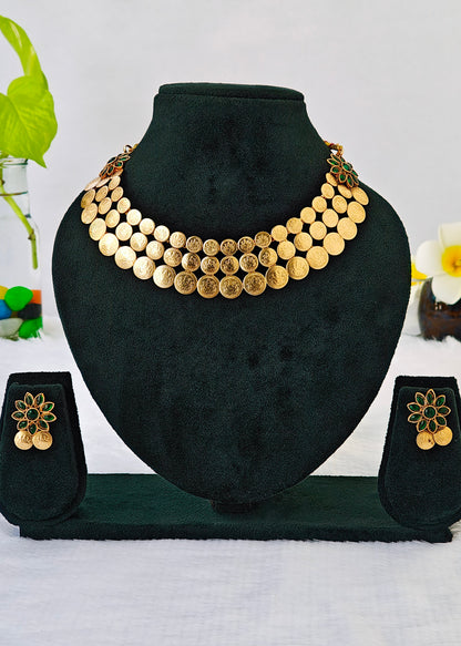 Gold coin necklace and matching flower earrings displayed on a black velvet jewelry bust and stand against a white background.