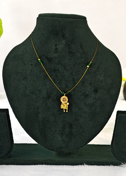 Avani fine-wire necklace with green beads and a floral mandala and elephant pendant on a black display.