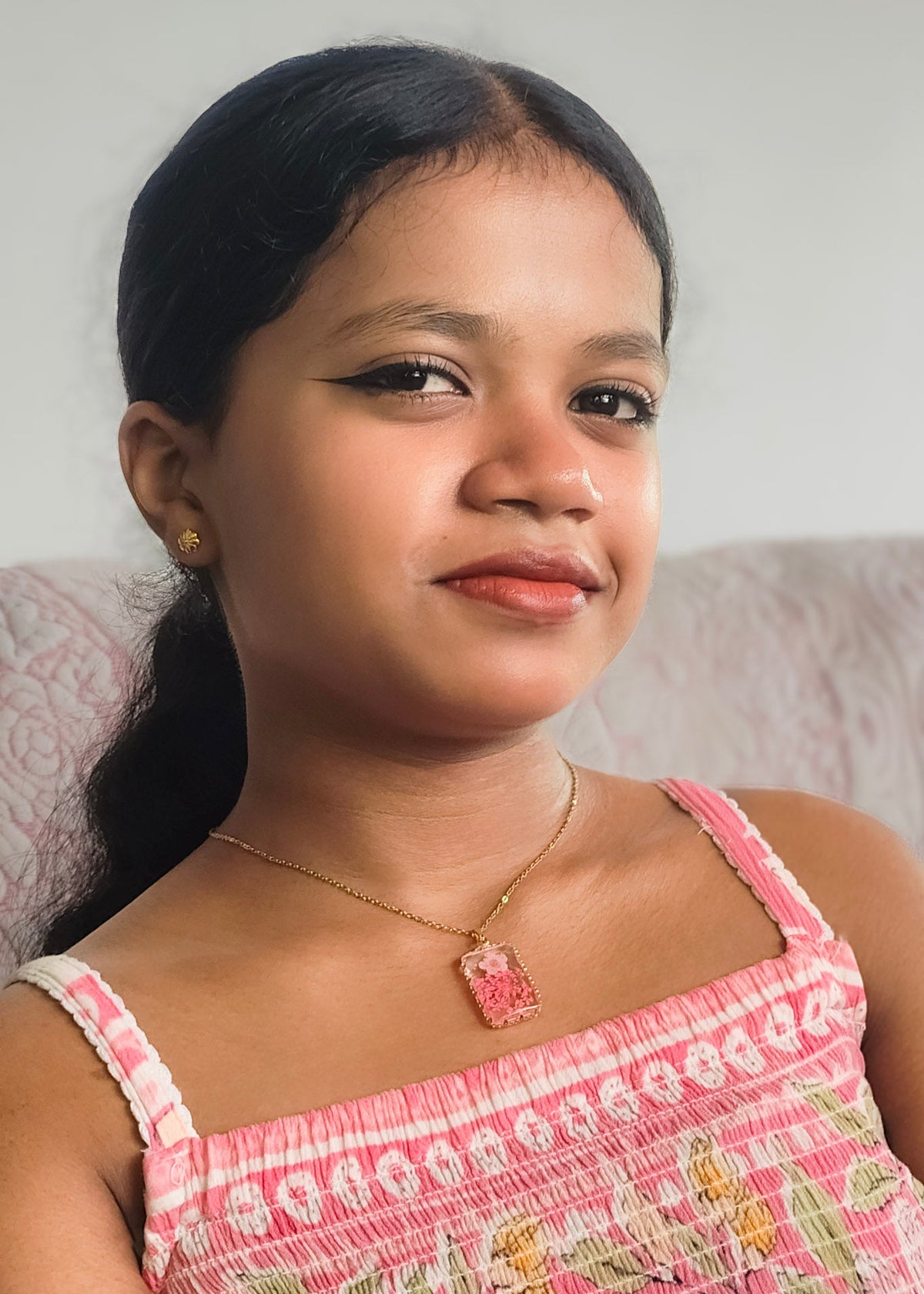 A young girl wearing anti tarnish  gold pendant necklace, 