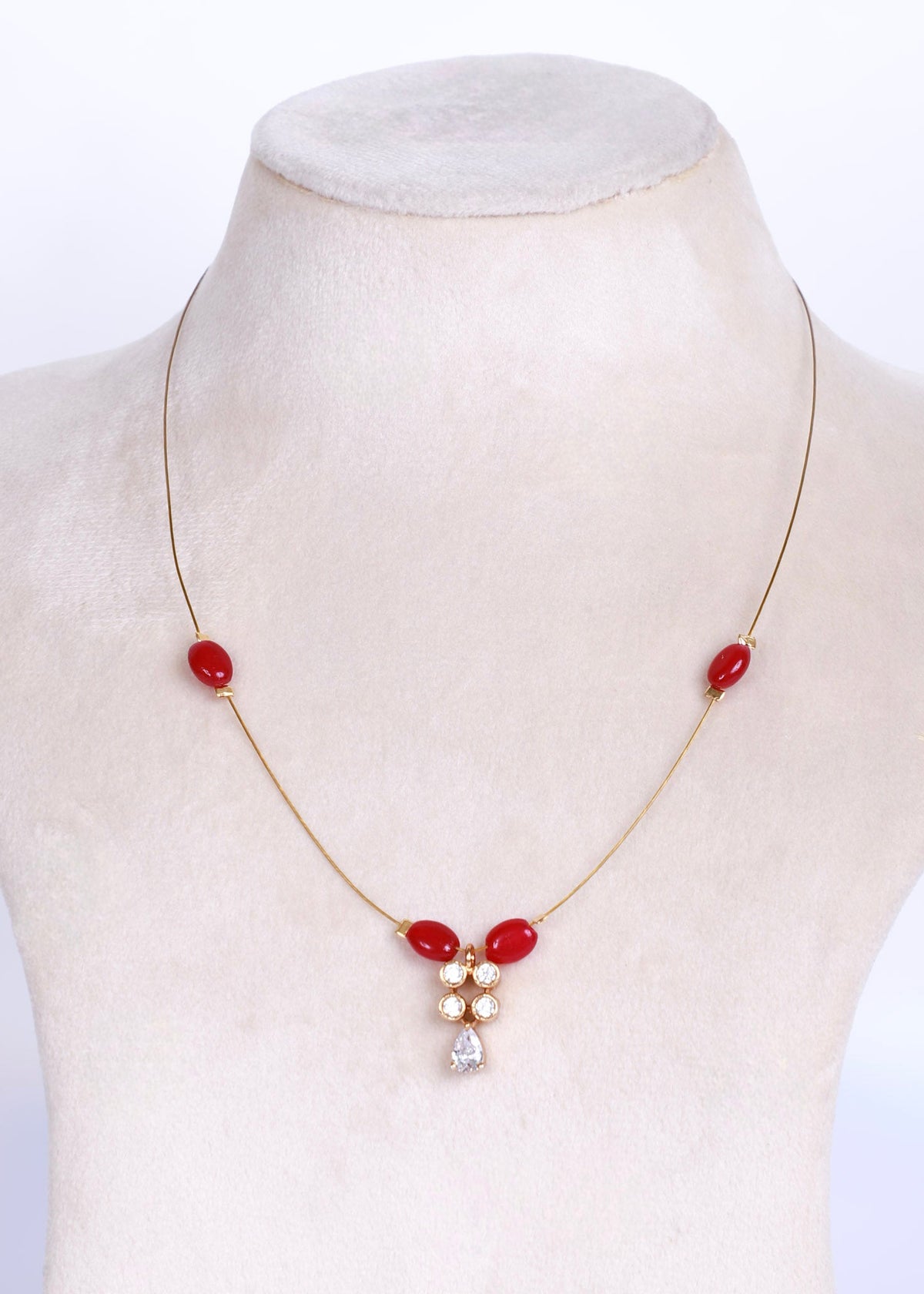An invisible necklace with ruby stones accents and white zirconia pendant.