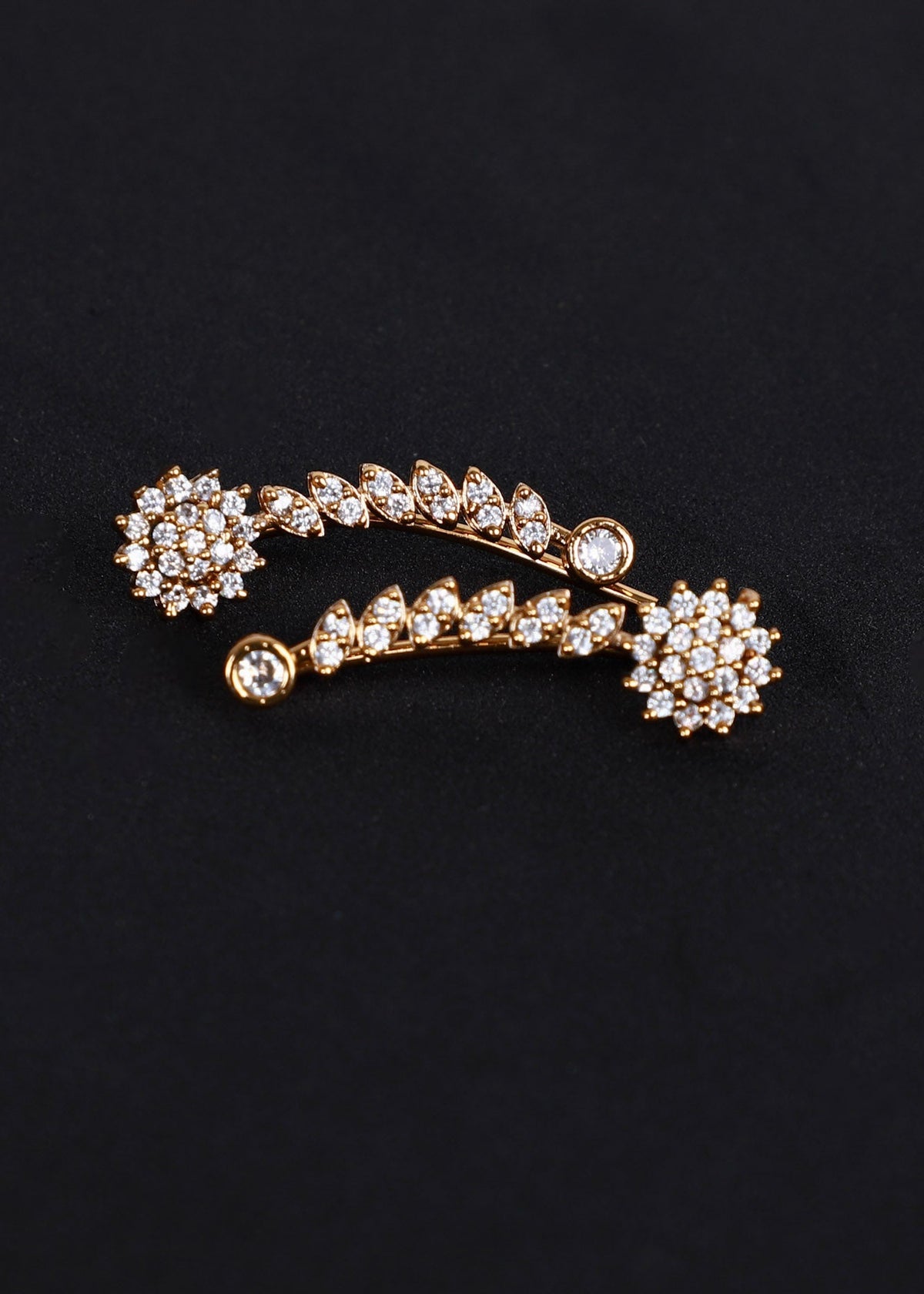 A gold-toned ear cuff adorned with clear rhinestones