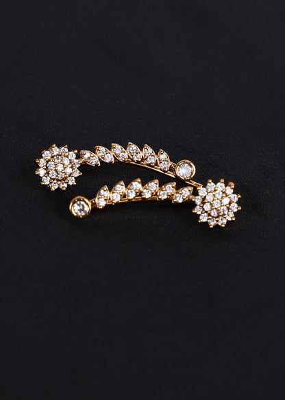 A gold-toned ear cuff adorned with clear rhinestones