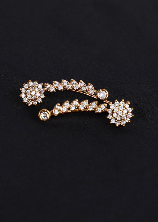 A gold-toned ear cuff adorned with clear rhinestones