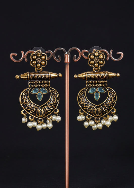 A pair of ornate gold-toned dangle earrings with light blue stone accents and white pearl drops
