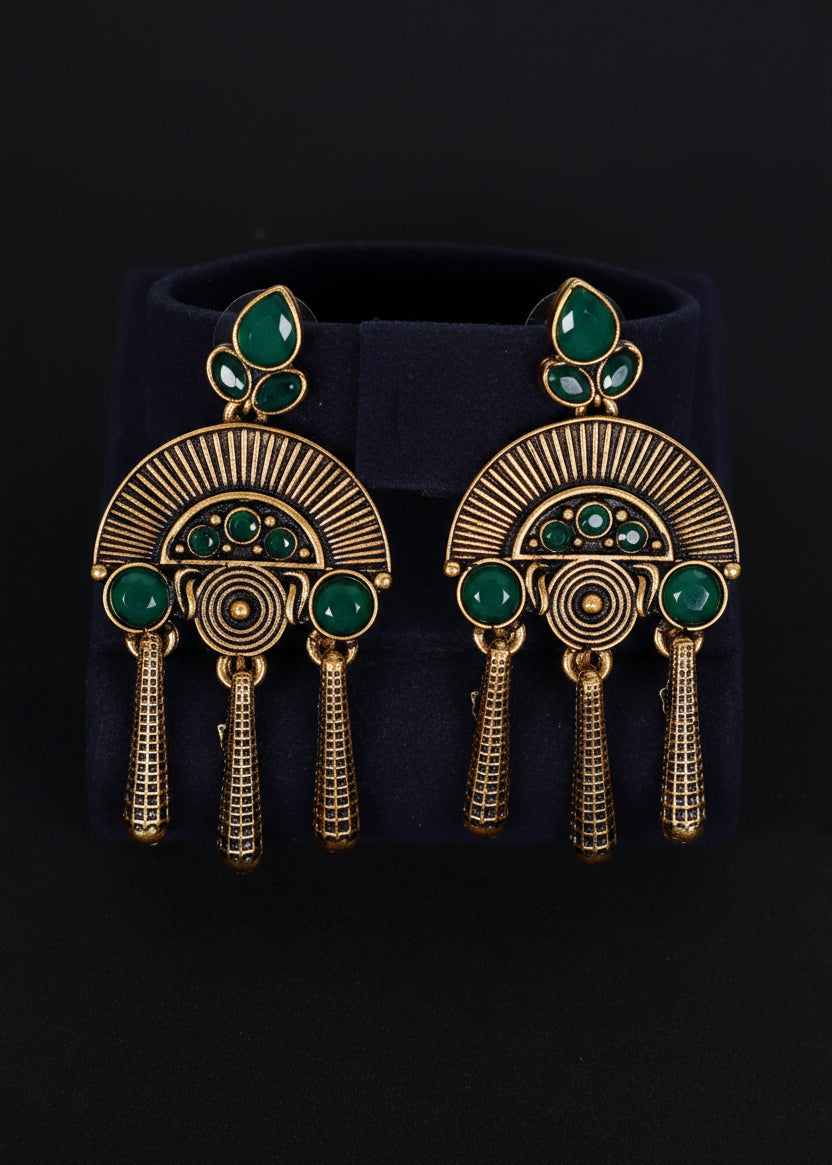 A pair of gold-toned statement earrings with green stone accents, 