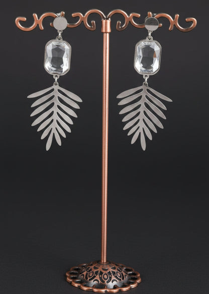 A pair of silver-toned dangle earrings with rectangular clear stones and leaf-shaped drops.