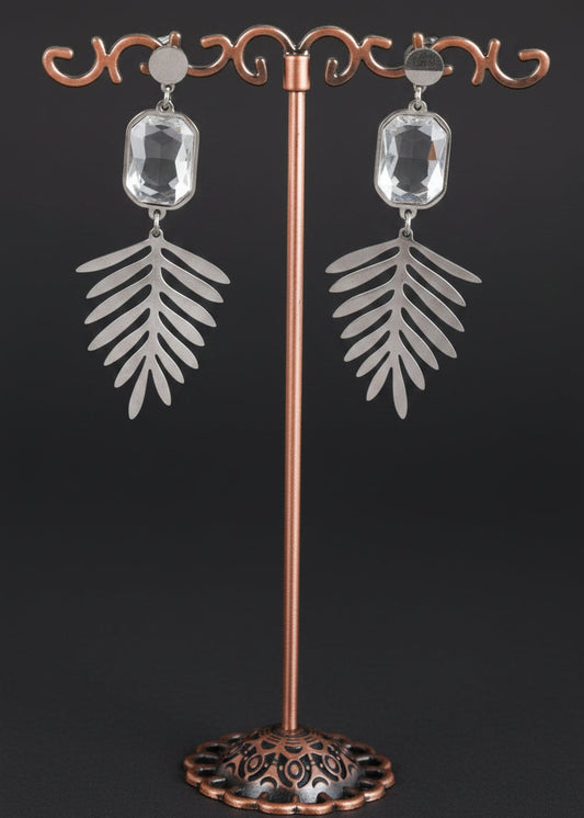 A pair of silver-toned dangle earrings with rectangular clear stones and leaf-shaped drops.